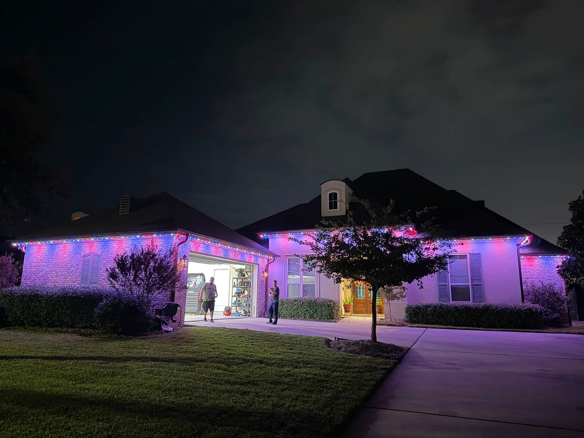 Holiday lighting installation on a Houston home