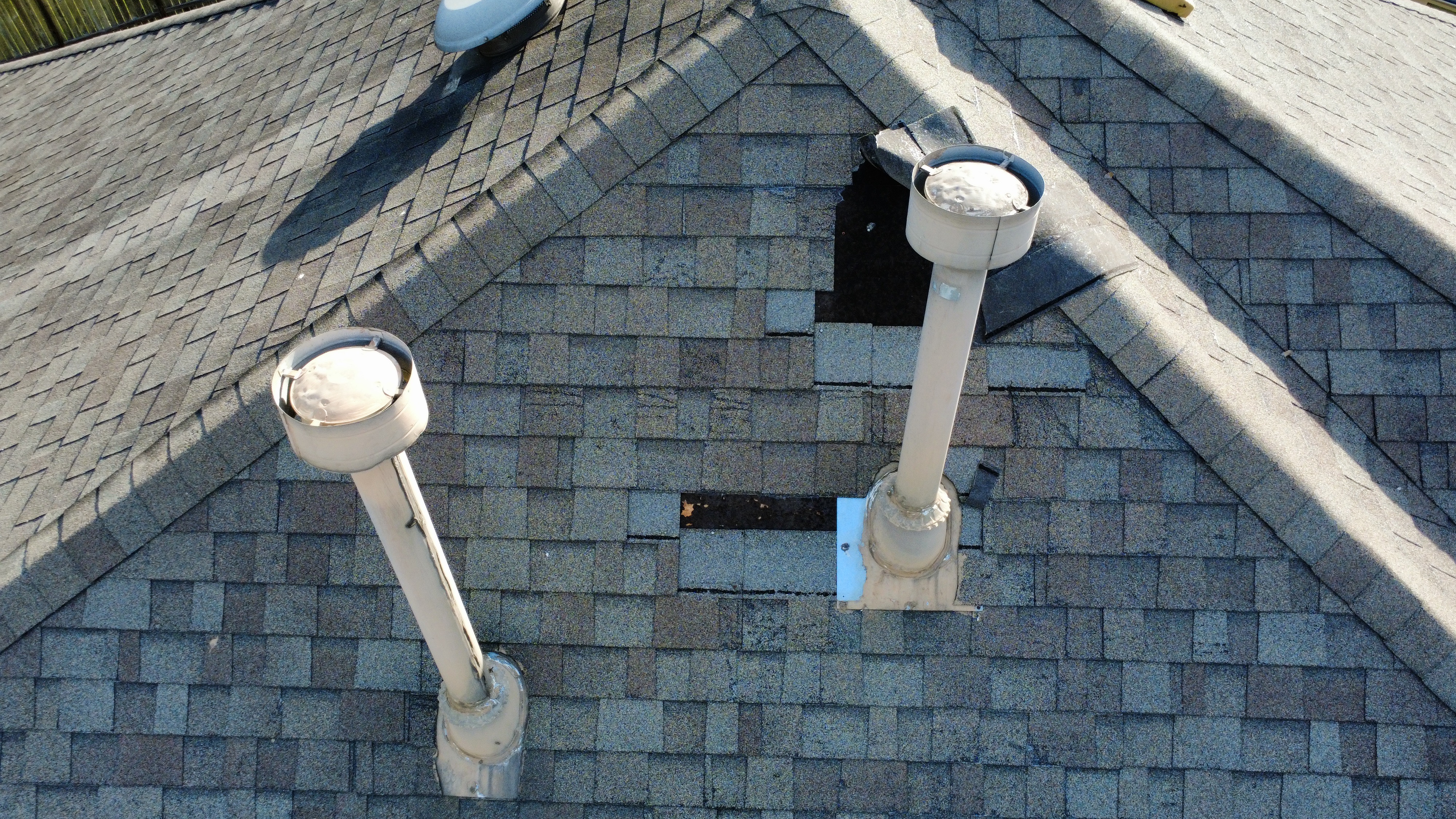 Lifted or missing shingle documented during a roof inspection