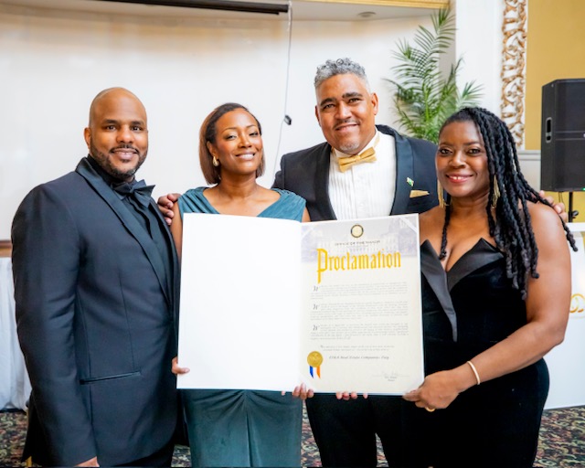 ESRA Realty LLC receiving a New York City Proclamation for 100 years of service in Harlem. Owners Maurice Russell Grey and Aden Seraile celebrate the firm's Centennial legacy of Black-owned real estate excellence.