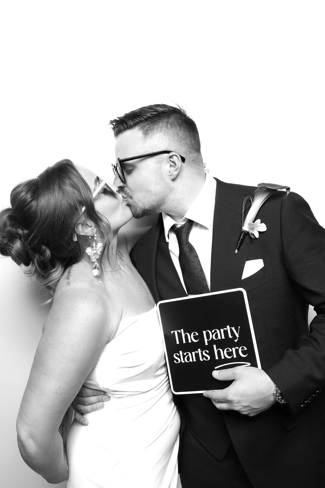 Newlyweds in a black and white Glam wedding photo booth in Lakewood Colorado