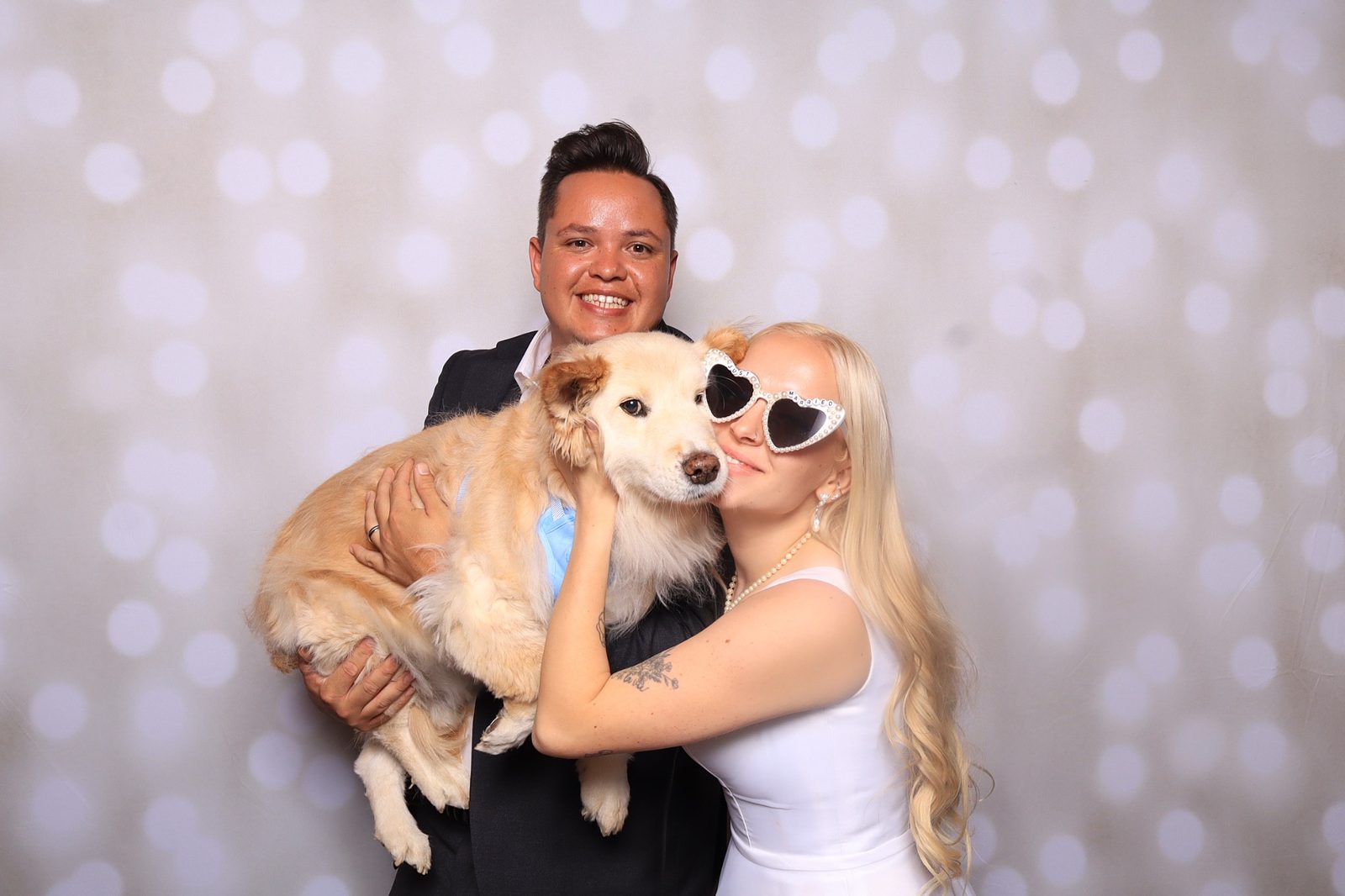 Newlyweds with their dog at a Martini Moment wedding photo booth at Spruce Mountain Ranch