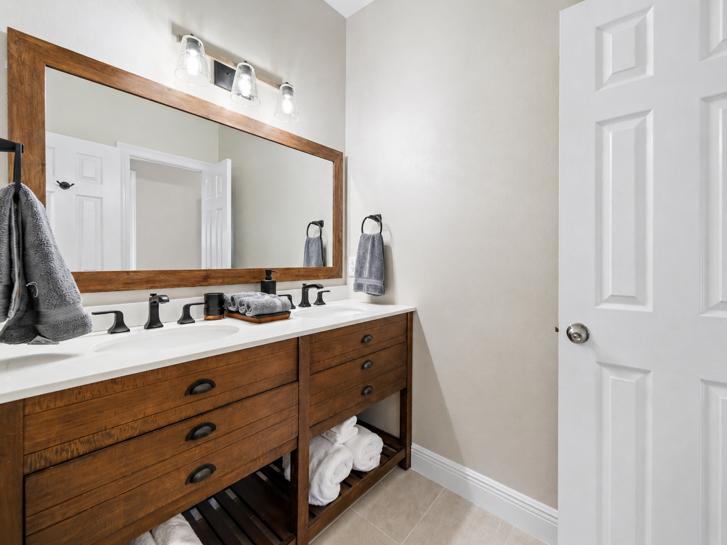 Wood vanity bathroom with mirror and towels at Sand Crab Hideaway