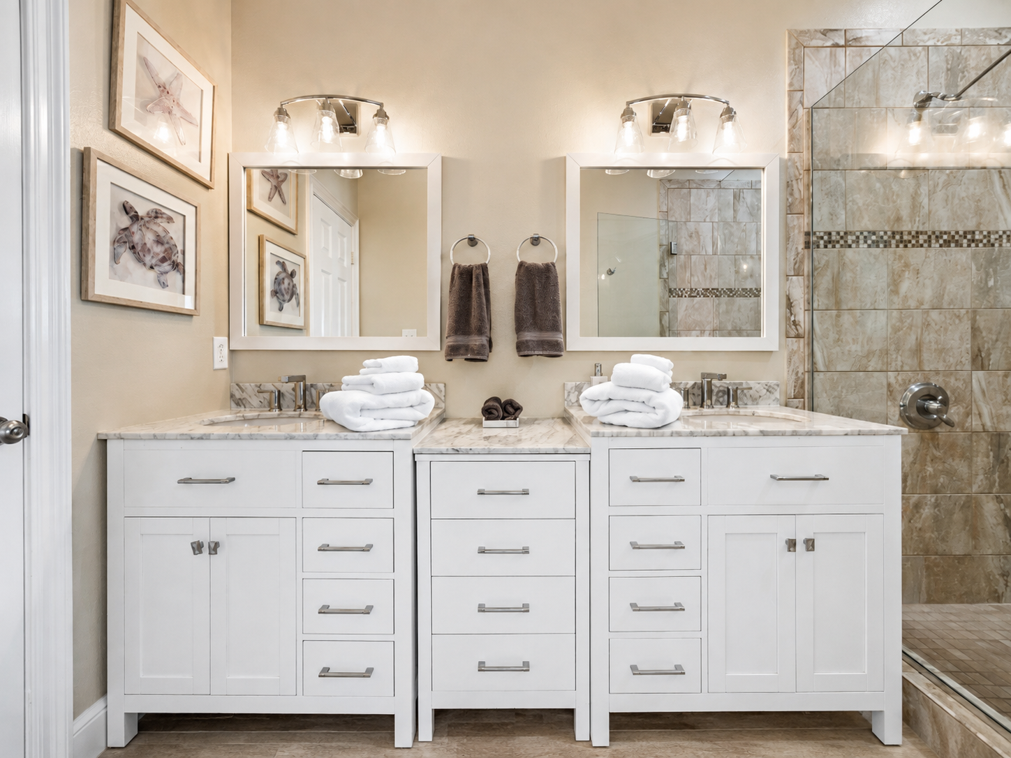 Bathroom vanity with fresh towels and glass shower at Sand Crab Hideaway