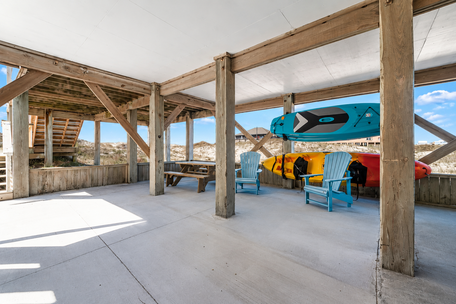 Sand Crab Hideaway covered outdoor space with kayaks