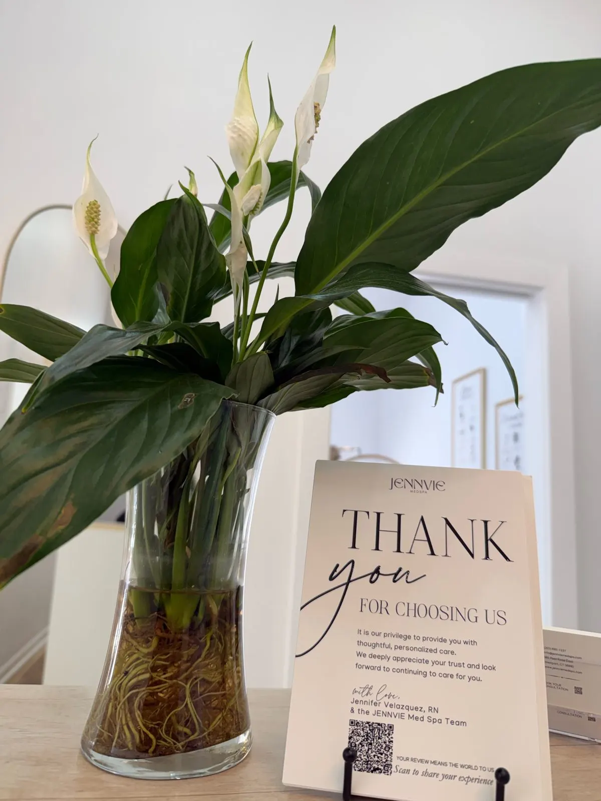 Thank-you card signed by Jennifer Velazquez, RN, beside a peace lily at JENNVIE in Westport, CT