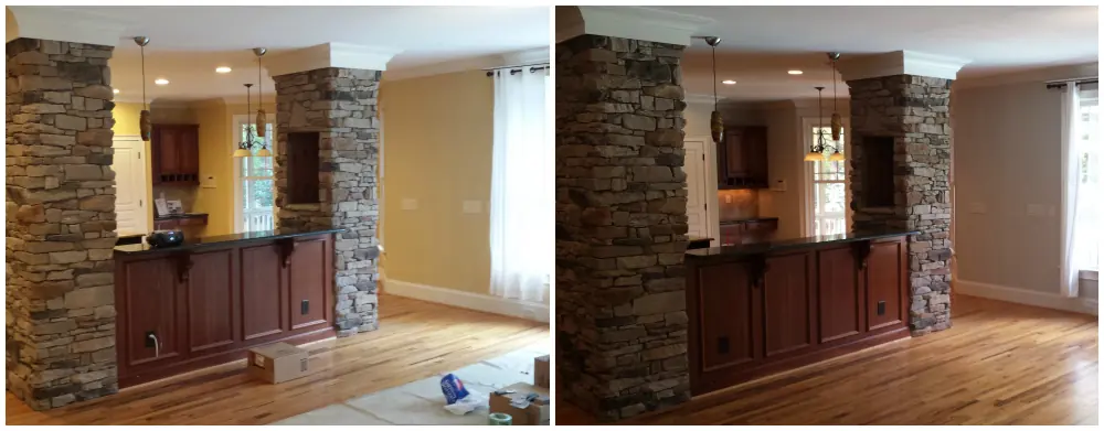 Kitchen area with stone pillars and dark wood bar after painting
