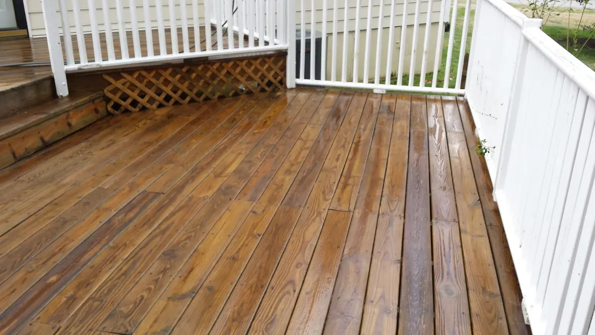 Freshly stained wooden deck with white railing