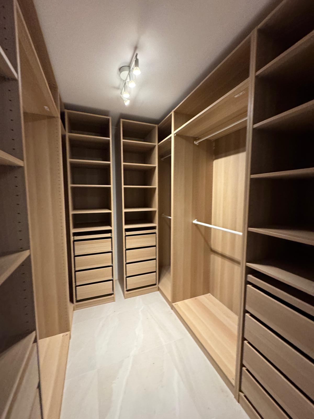 Large walk-in wardrobe installation with drawers and shelving