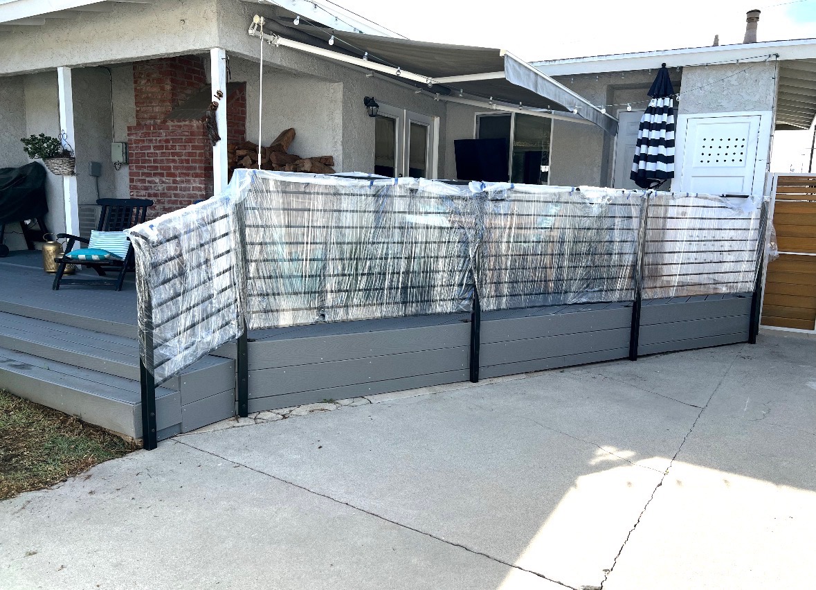Black horizontal slat patio railing installation in progress
