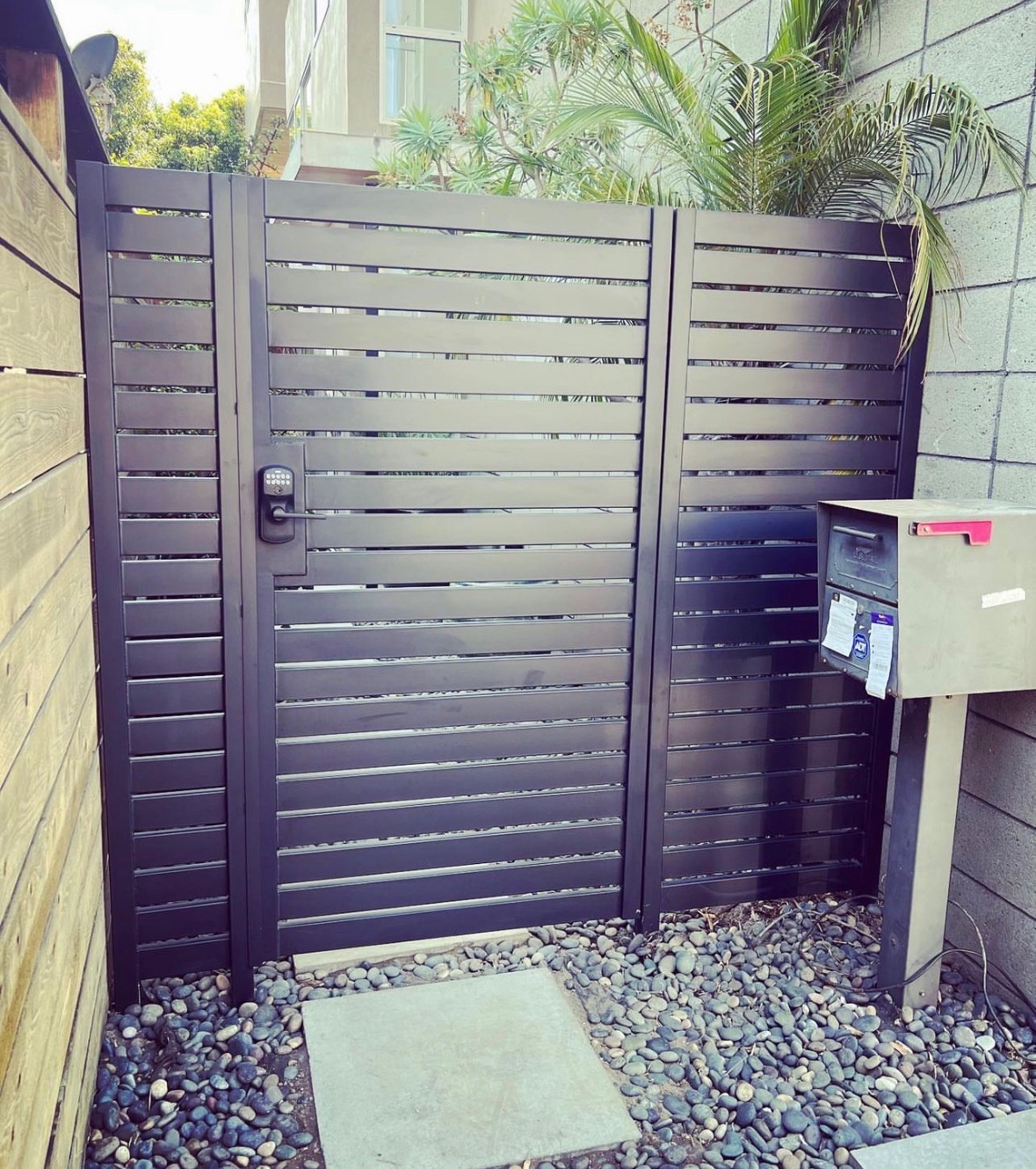 Modern black horizontal iron patio railing and gate installation