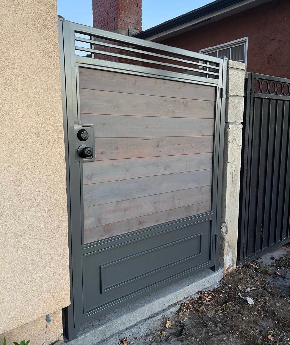 Steel-frame wood pedestrian gate with horizontal cedar panels