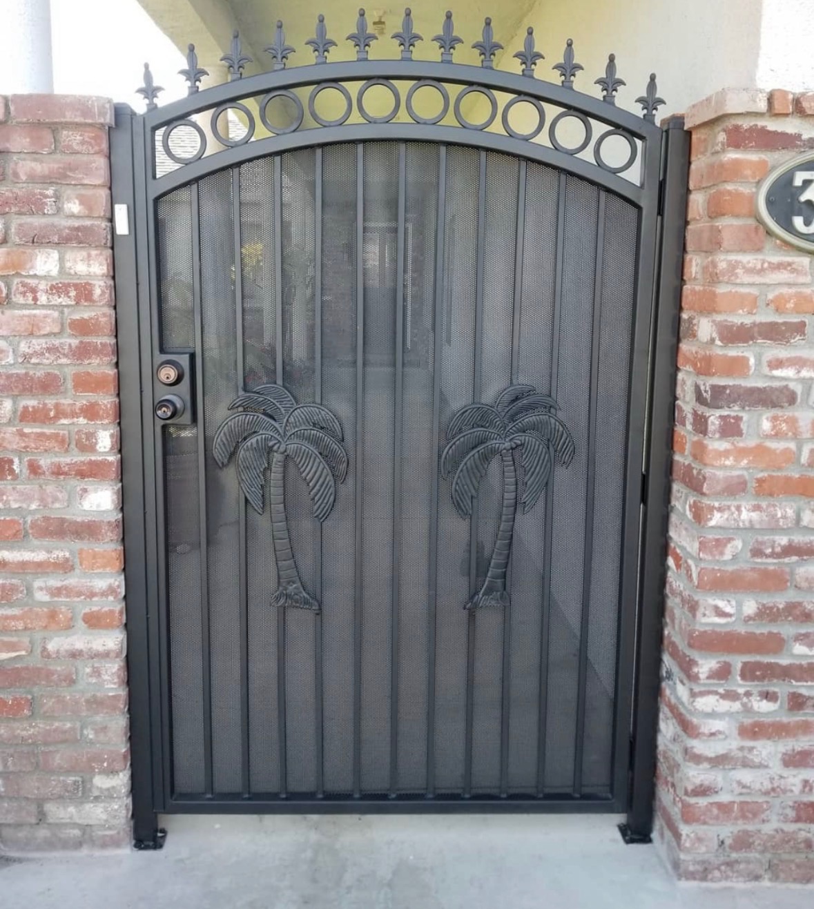 Custom ornamental pedestrian gate with a palm tree design motif
