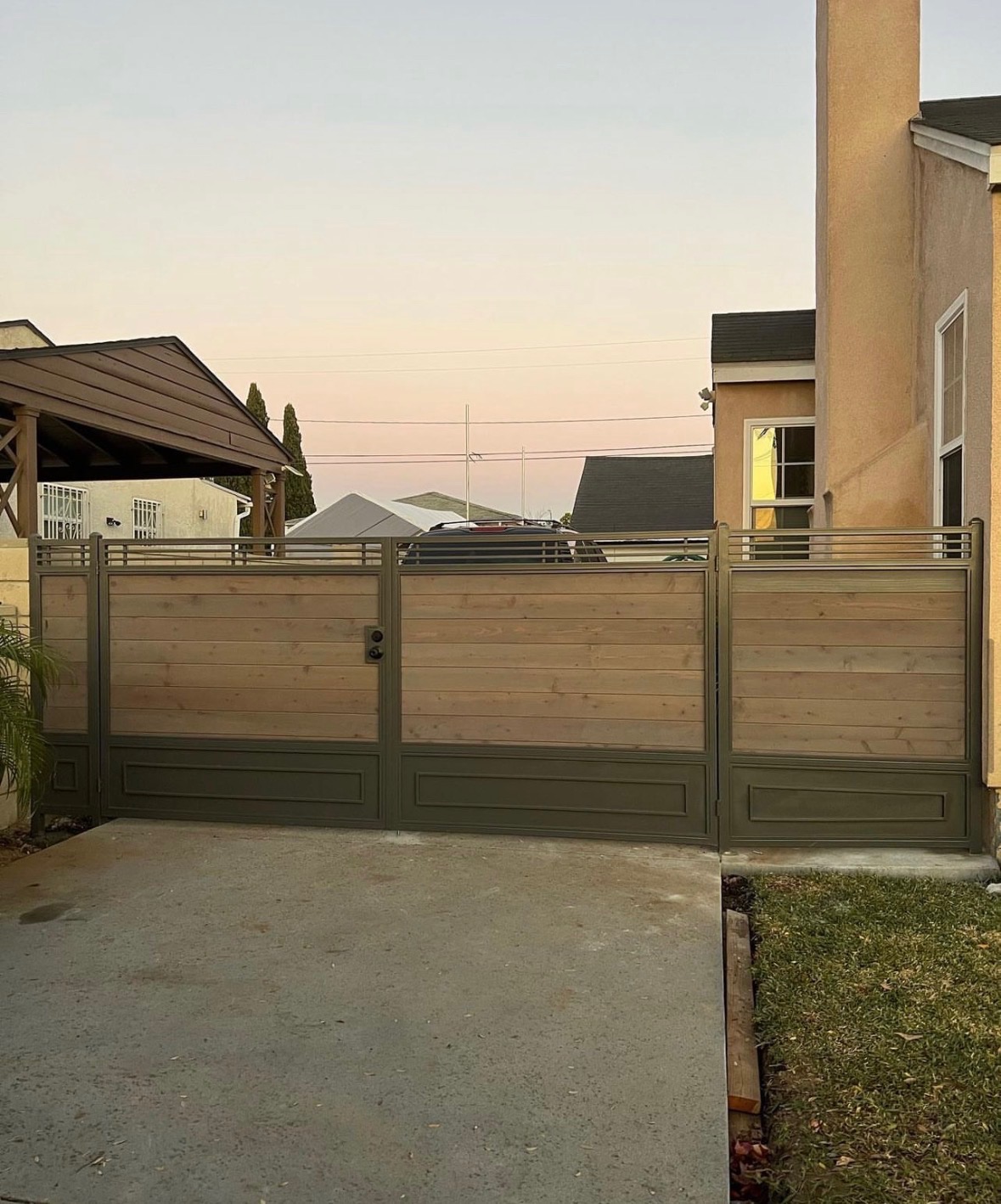 Steel and wood driveway gate with modern horizontal slat design