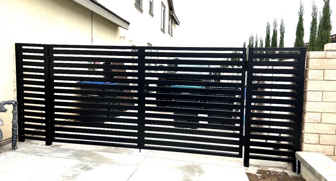 Modern black horizontal driveway gate installation
