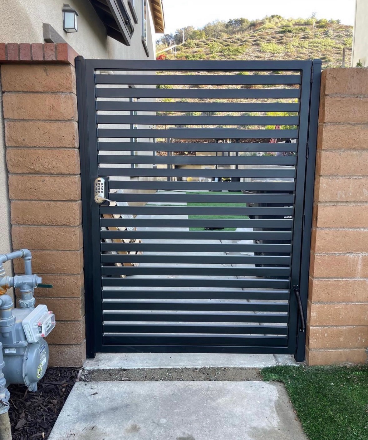 Modern black horizontal side gate with keypad lock entry