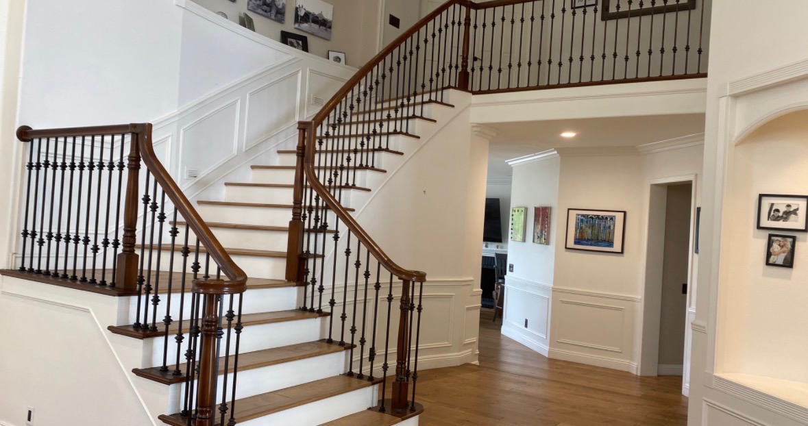 Traditional mahogany handrail with wrought iron balusters in a staircase gallery hall