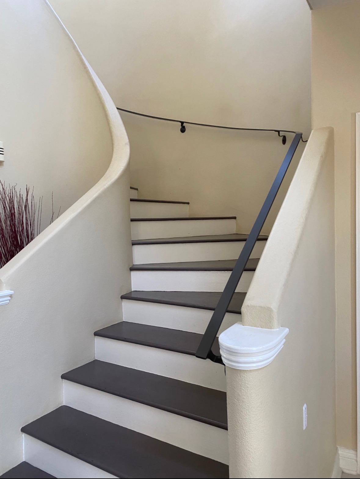 Curved staircase black iron handrail repair in progress