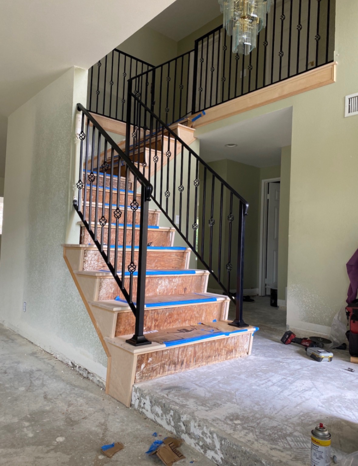 Black wrought iron staircase railing scroll and baluster repair