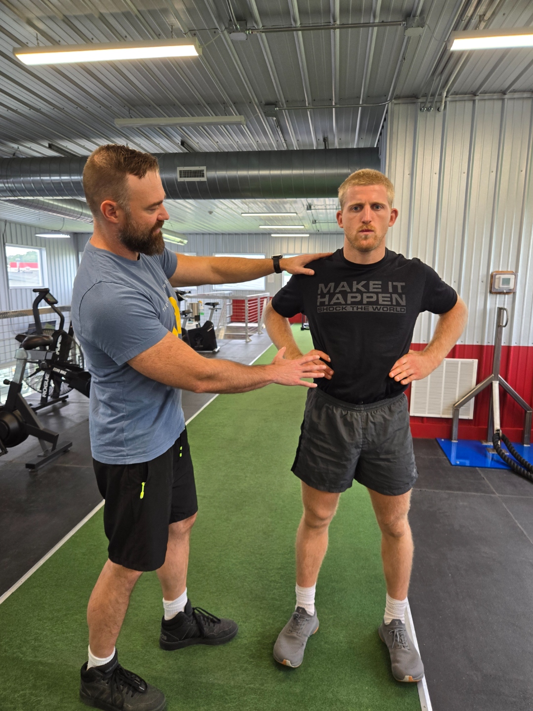 Coach assessing an athlete's breathing and posture during a baseline test