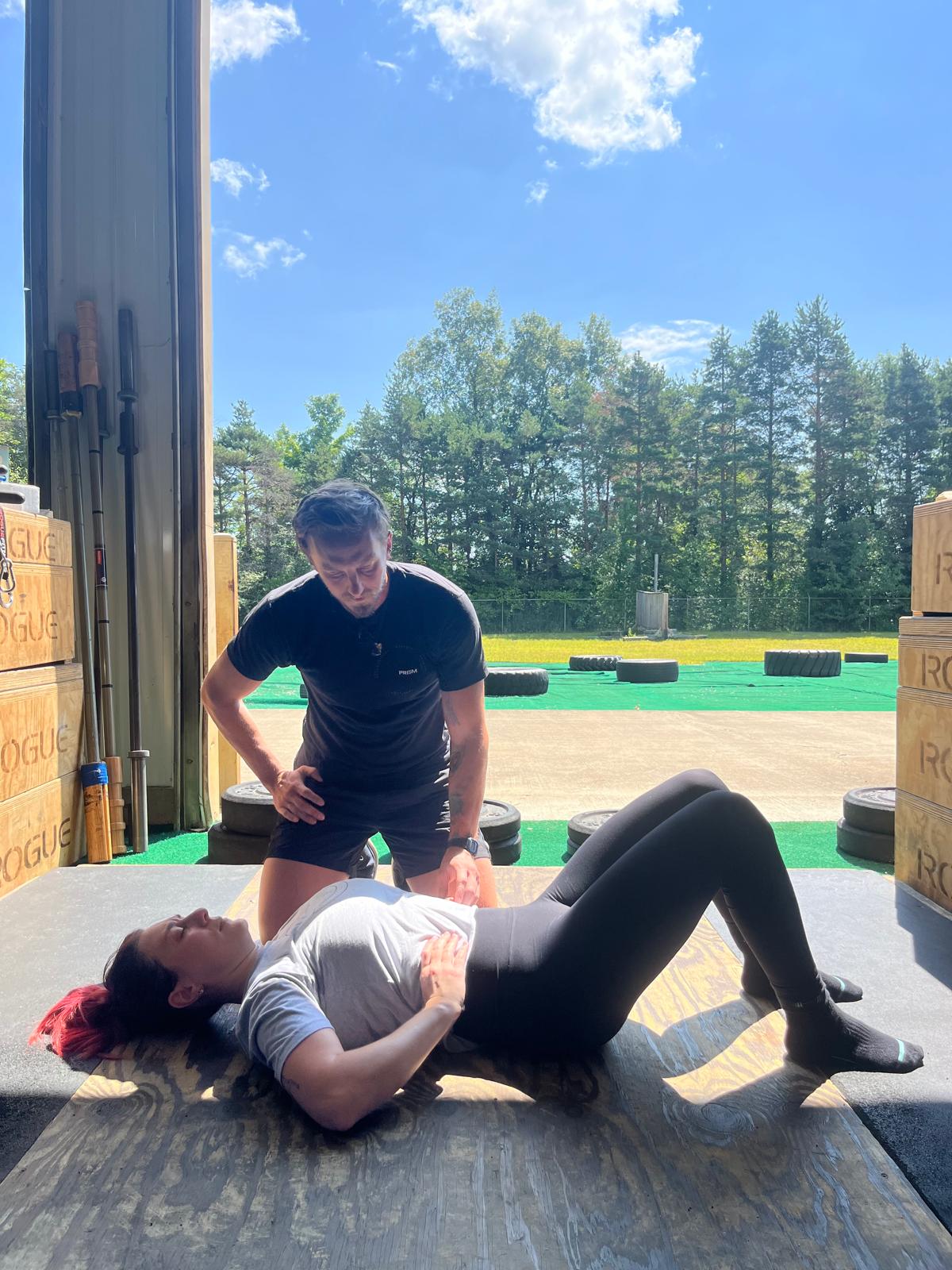 Breath assessment on a mat at an outdoor training facility