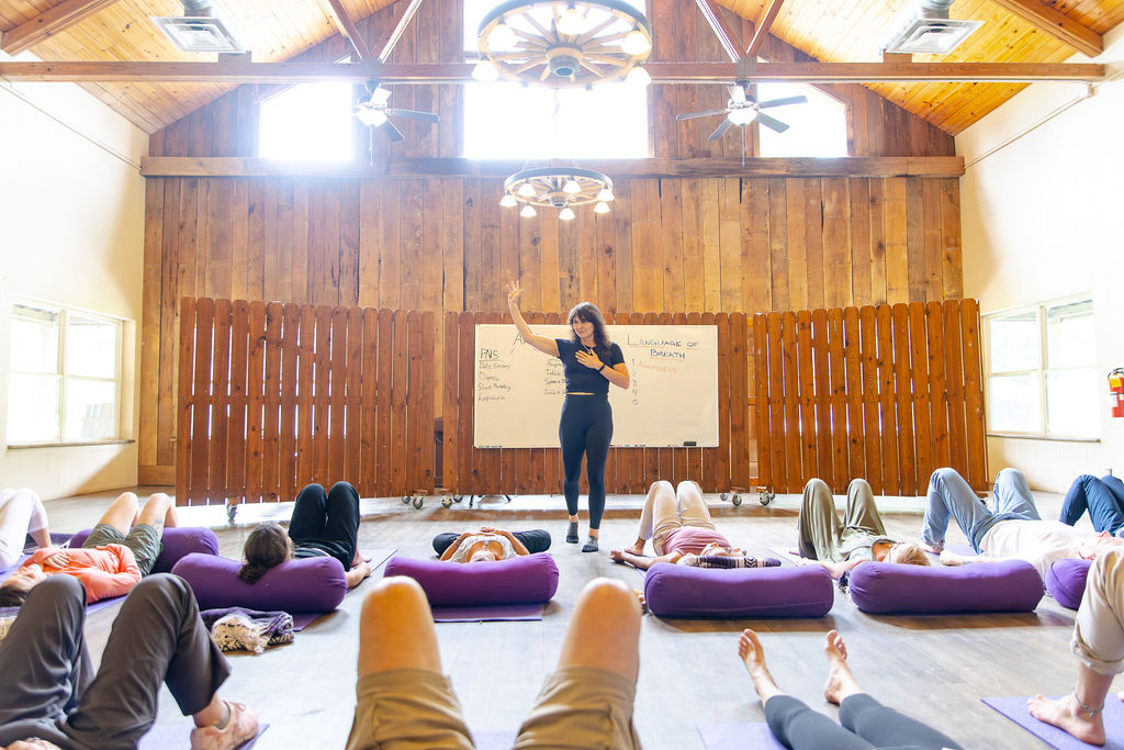 A full Language of Breath session in progress, participants working on mats