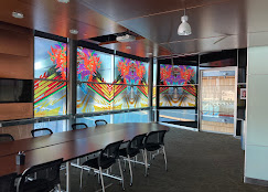 Corporate conference room vivid full-color art panels on glass walls