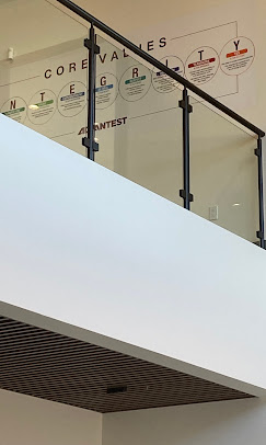 Advantest corporate frosted vinyl core values display on interior glass railings
