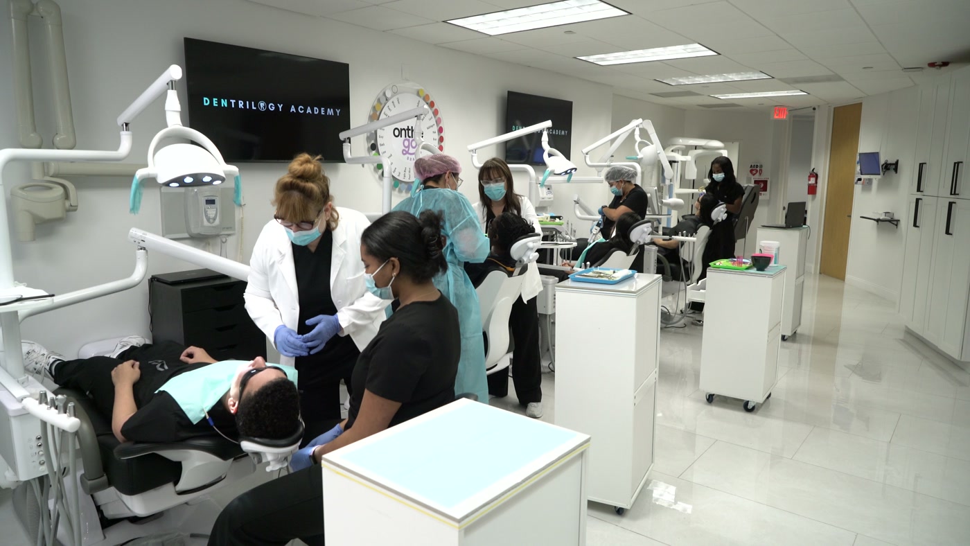 Students training chairside in the Dentrilogy West Palm Beach clinic