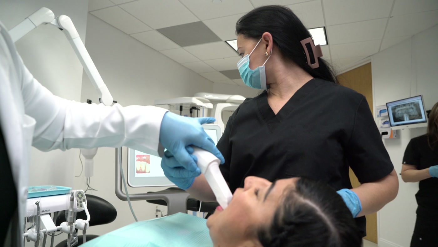 Dentrilogy instructor and student working chairside in the clinic