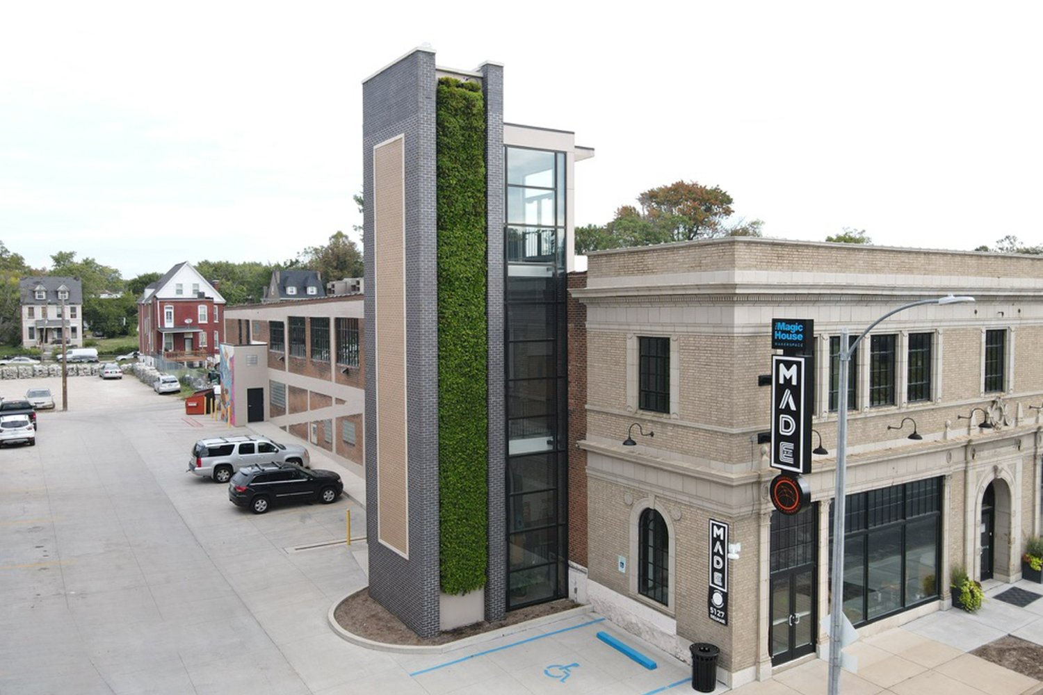 Multi-story commercial living wall tower on a corner retail building