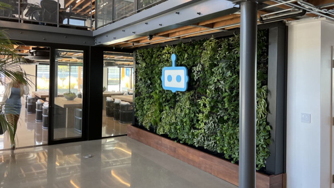Office lobby living wall behind floor-to-ceiling glass
