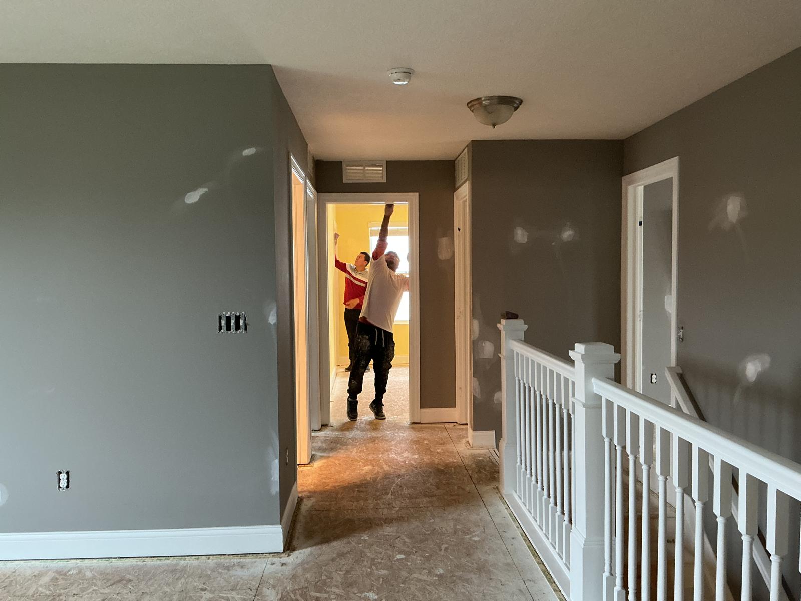White painted room with green LED accent lighting and cabinets