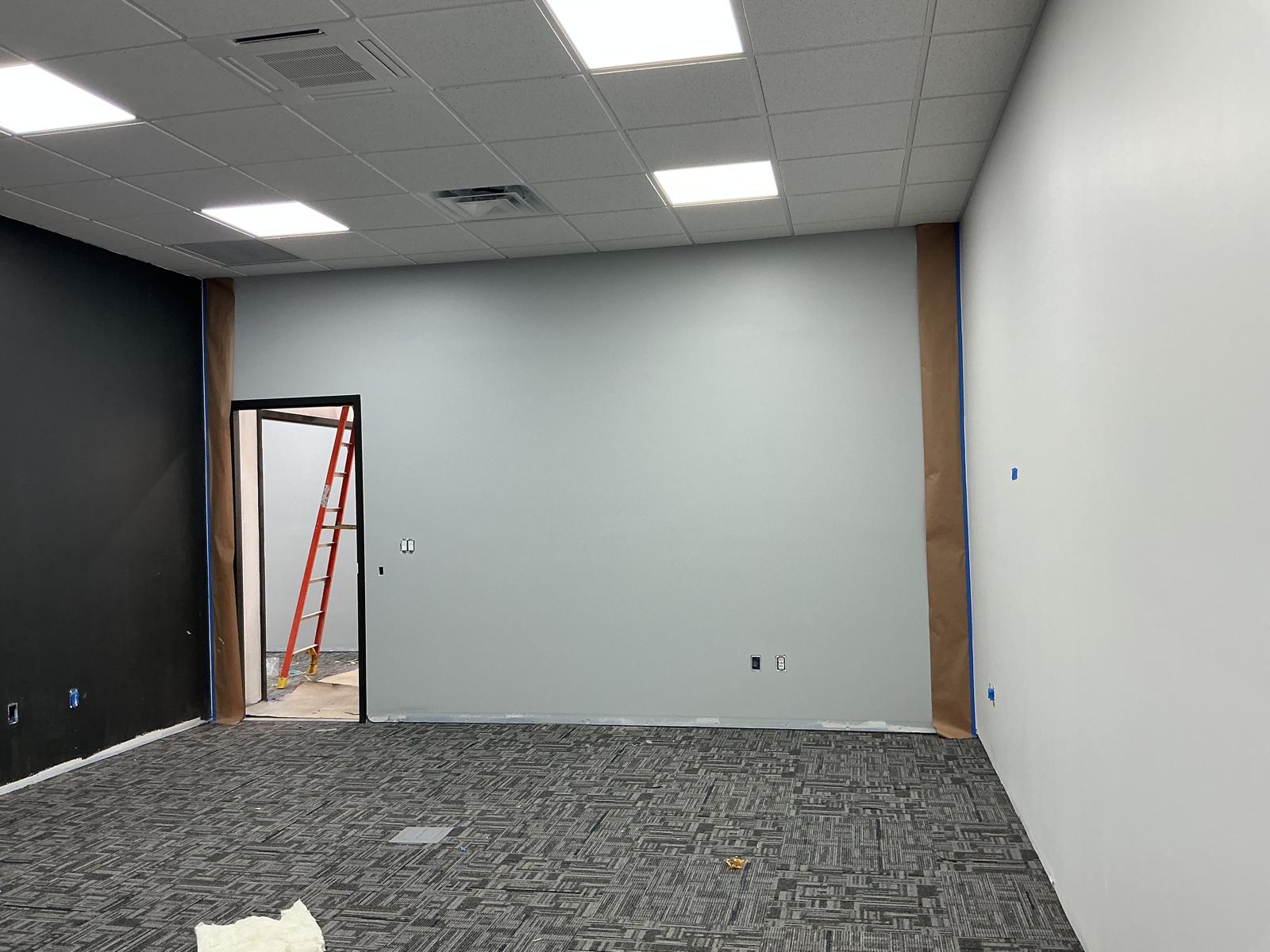 Hallway with fresh light gray-blue paint and dark door frames