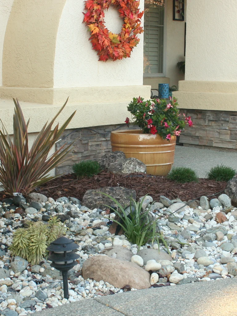 Granite Bay front entry stonework, river rock, planting, and landscape design by Lavish Gardens Landscape