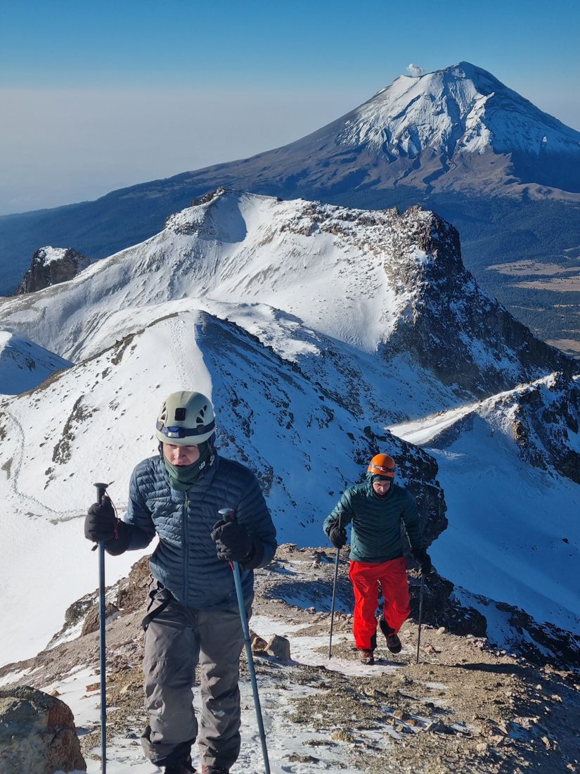 Two climbers on the Iztaccihuatl ridge with Popocatepetl behind