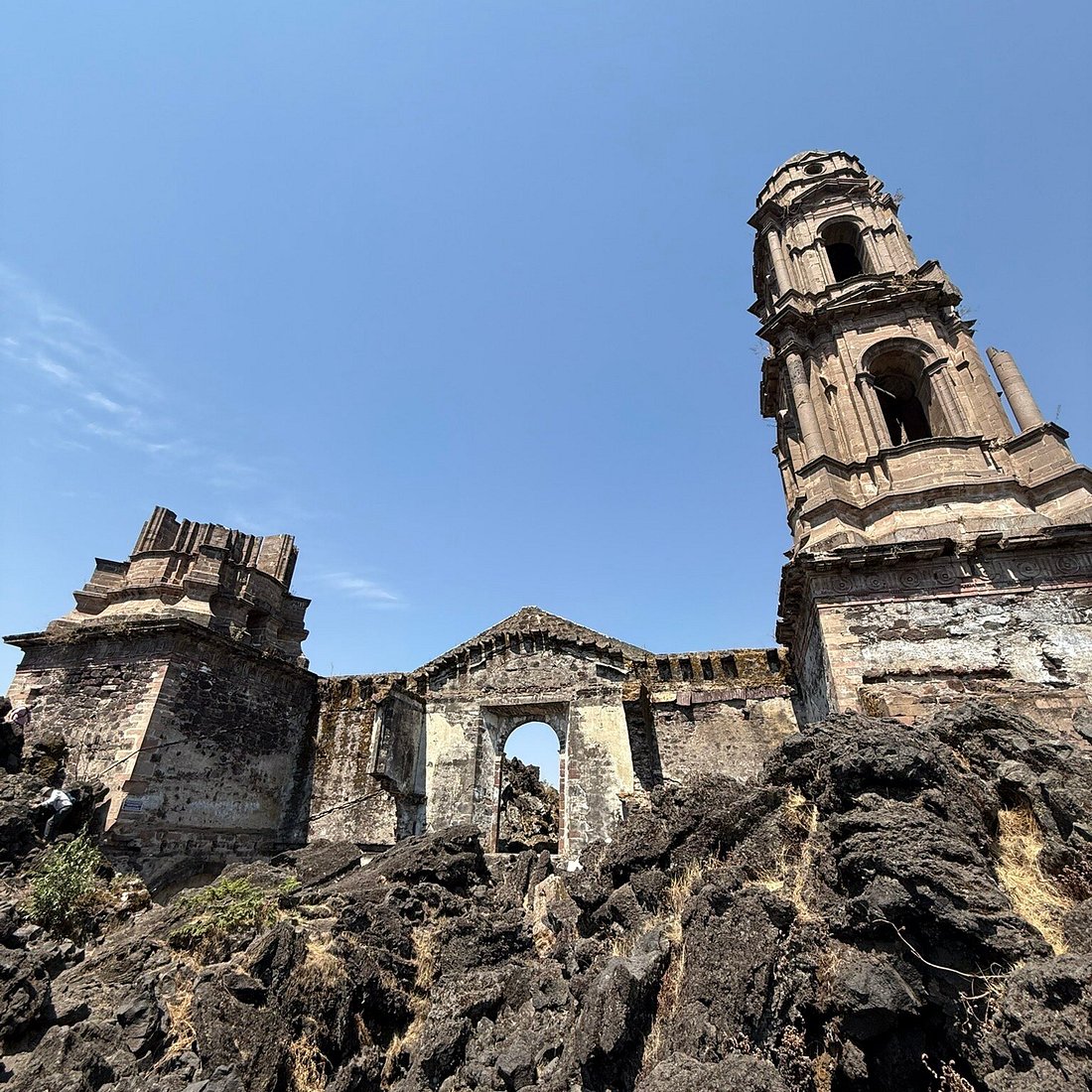 The buried church of San Juan Parangaricutiro rising out of the lava field at Paricut&iacute;n