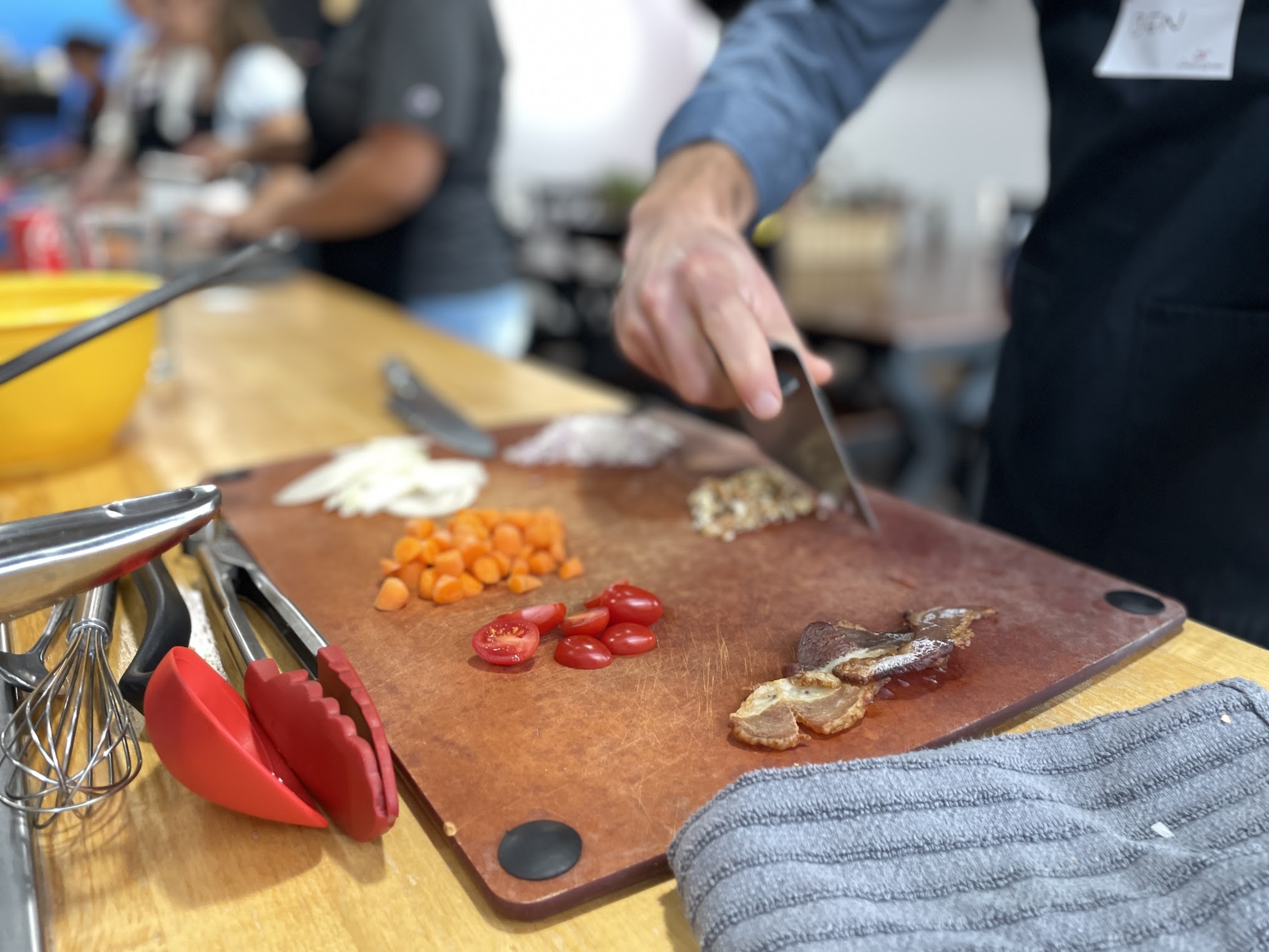 Prepped vegetables organized on a cutting board for mise en place during a hands-on cooking class Prepped vegetables organized on a cutting board for mise en place during a hands-on cooking class