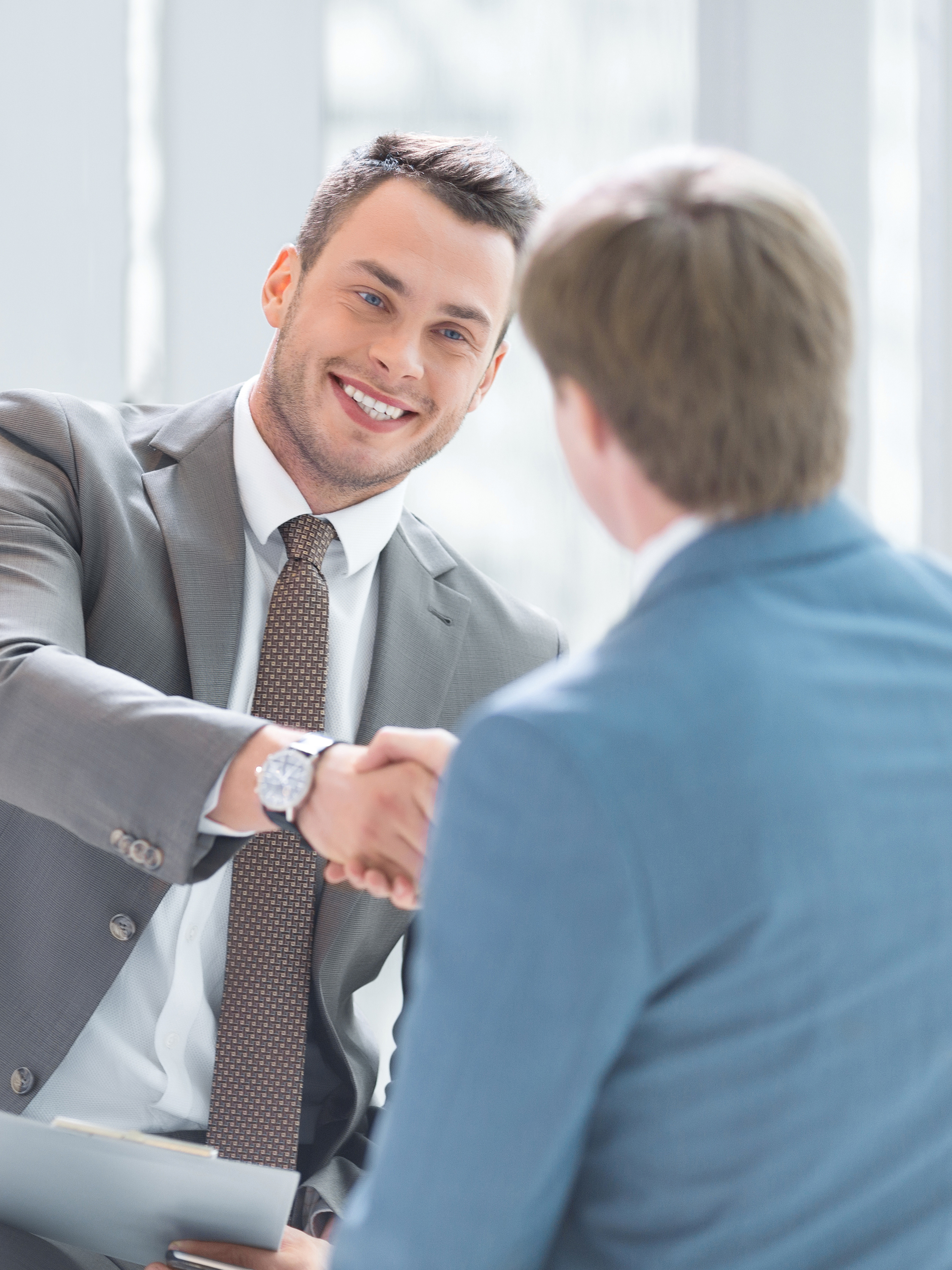 Two people shaking hands after closing a successful agreement
