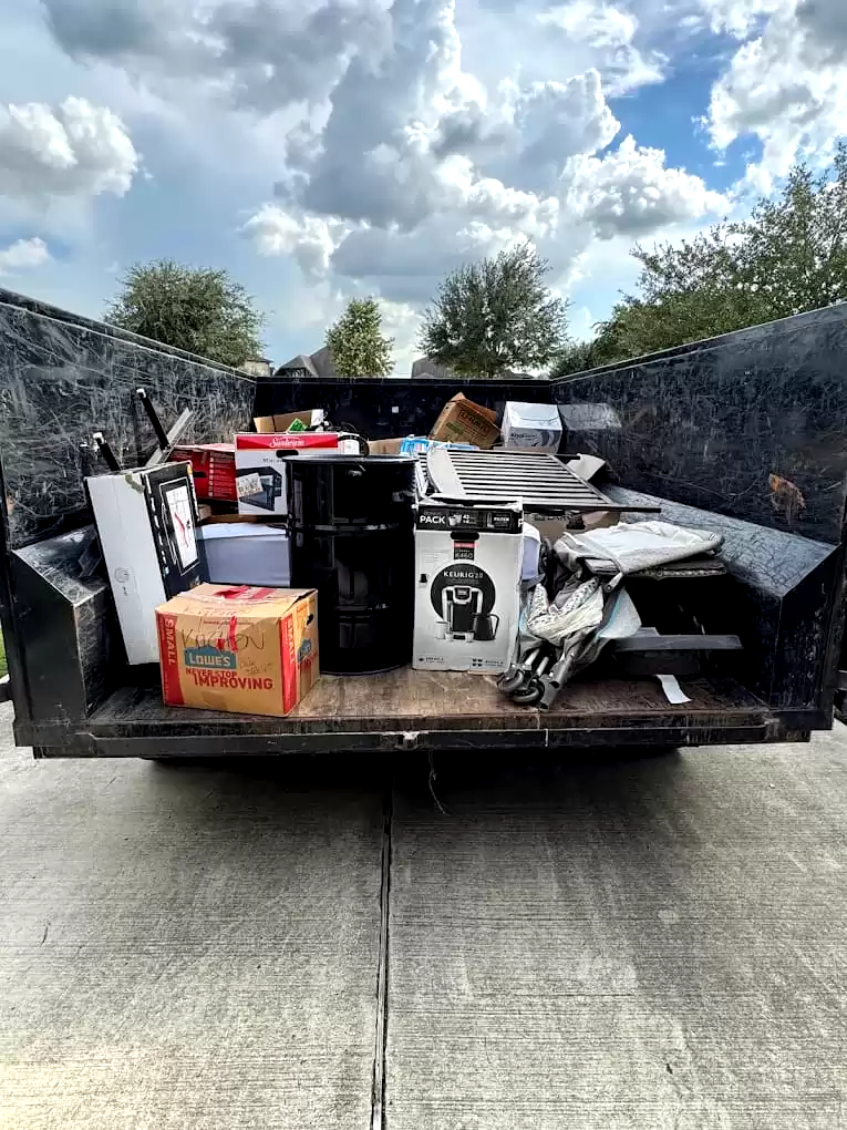 Appliances, boxes and household items loaded in a trailer