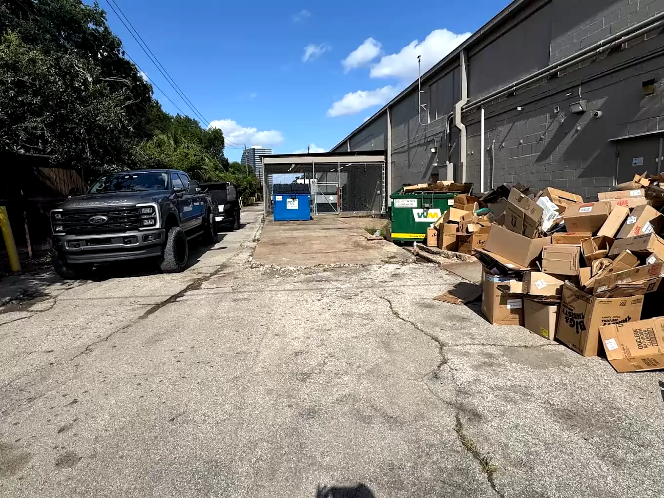 Cardboard boxes and debris beside a commercial building