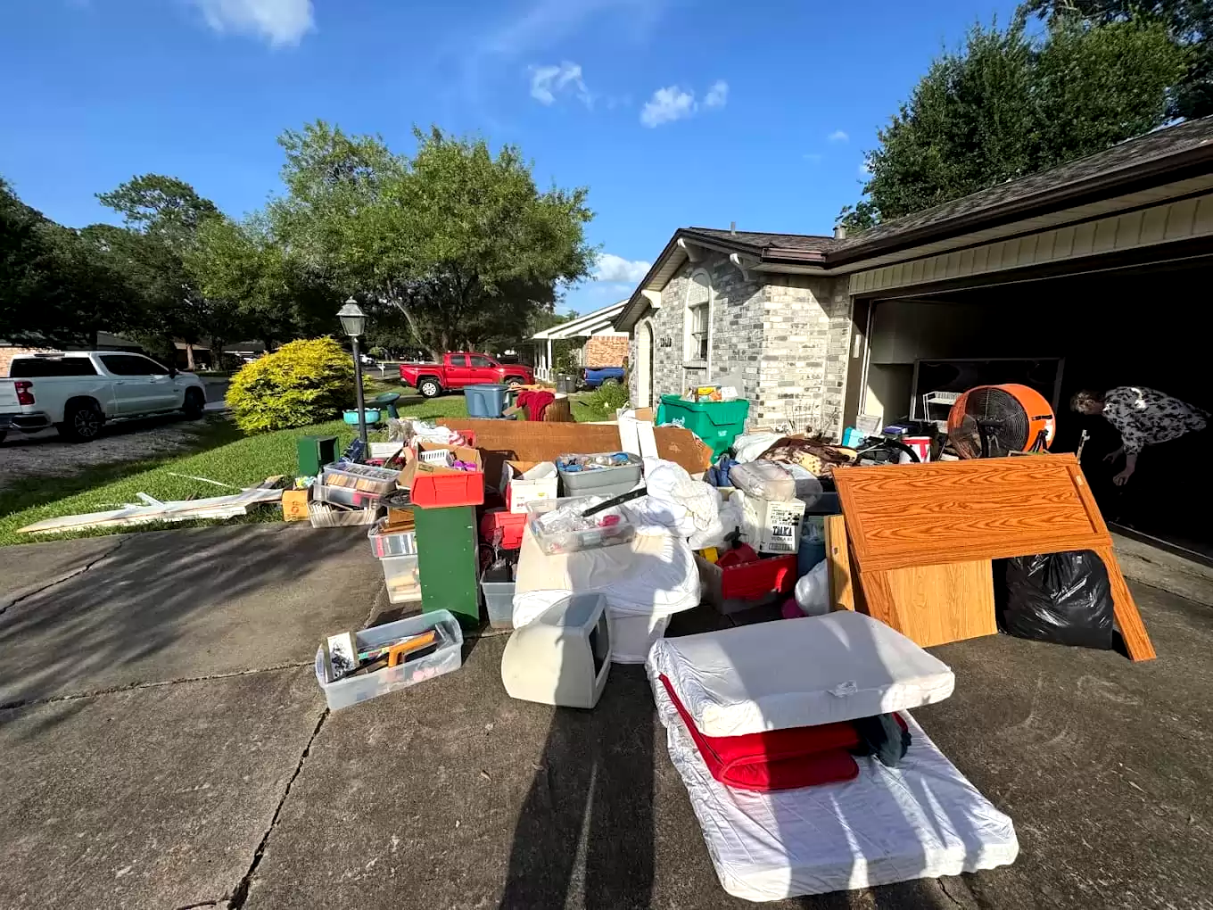 Household goods and containers outside an open garage