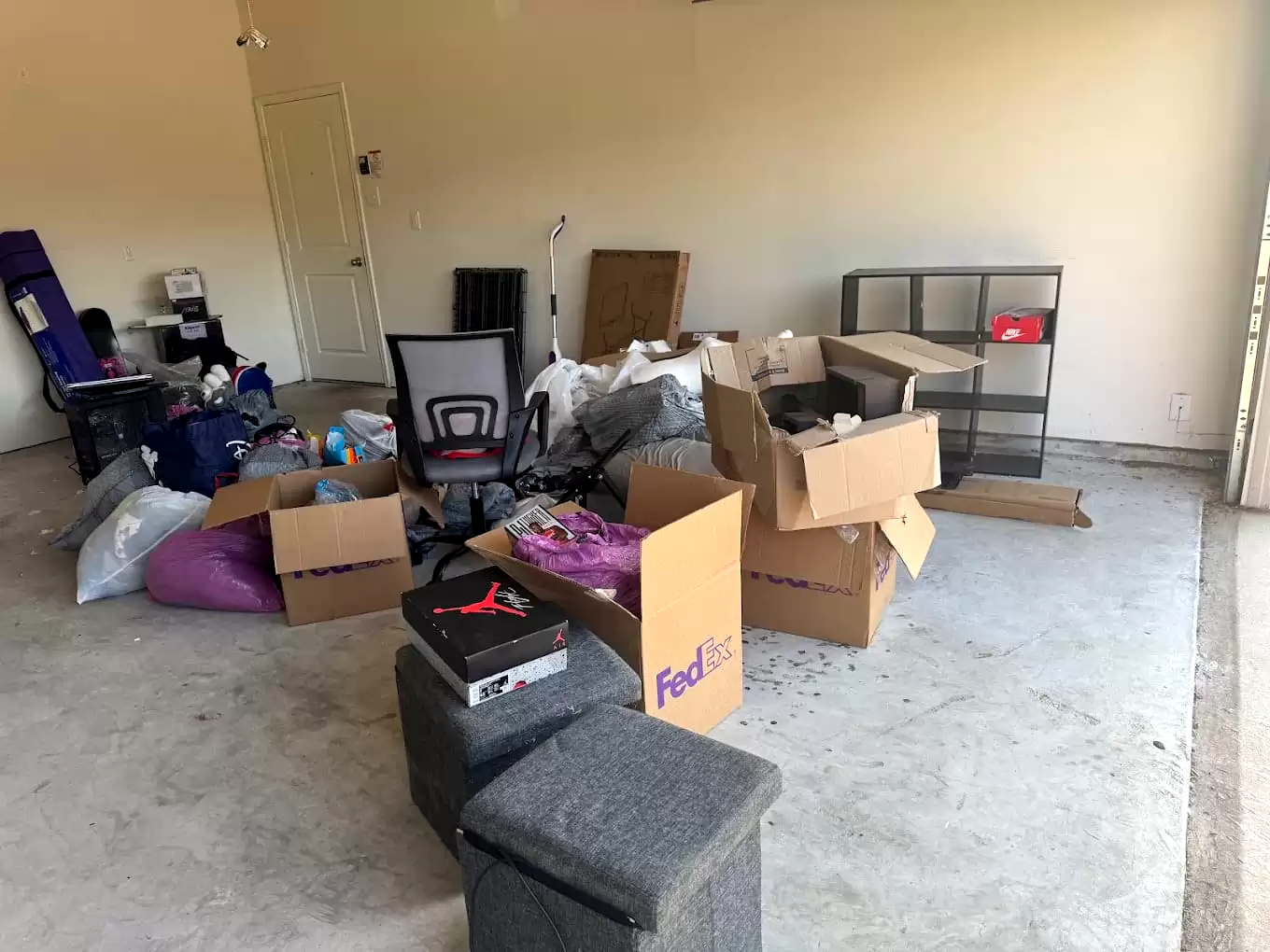 Boxes, shelving and household items gathered in a garage