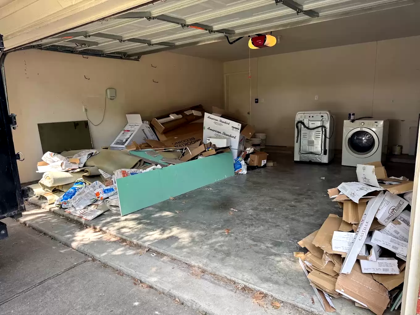 Cardboard and renovation debris inside a garage
