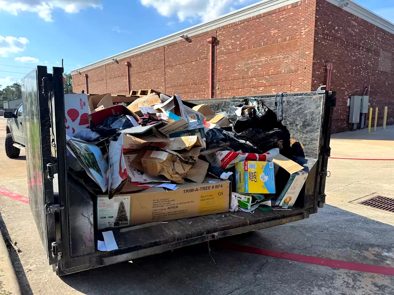 Mixed household items and bags loaded in a dump trailer