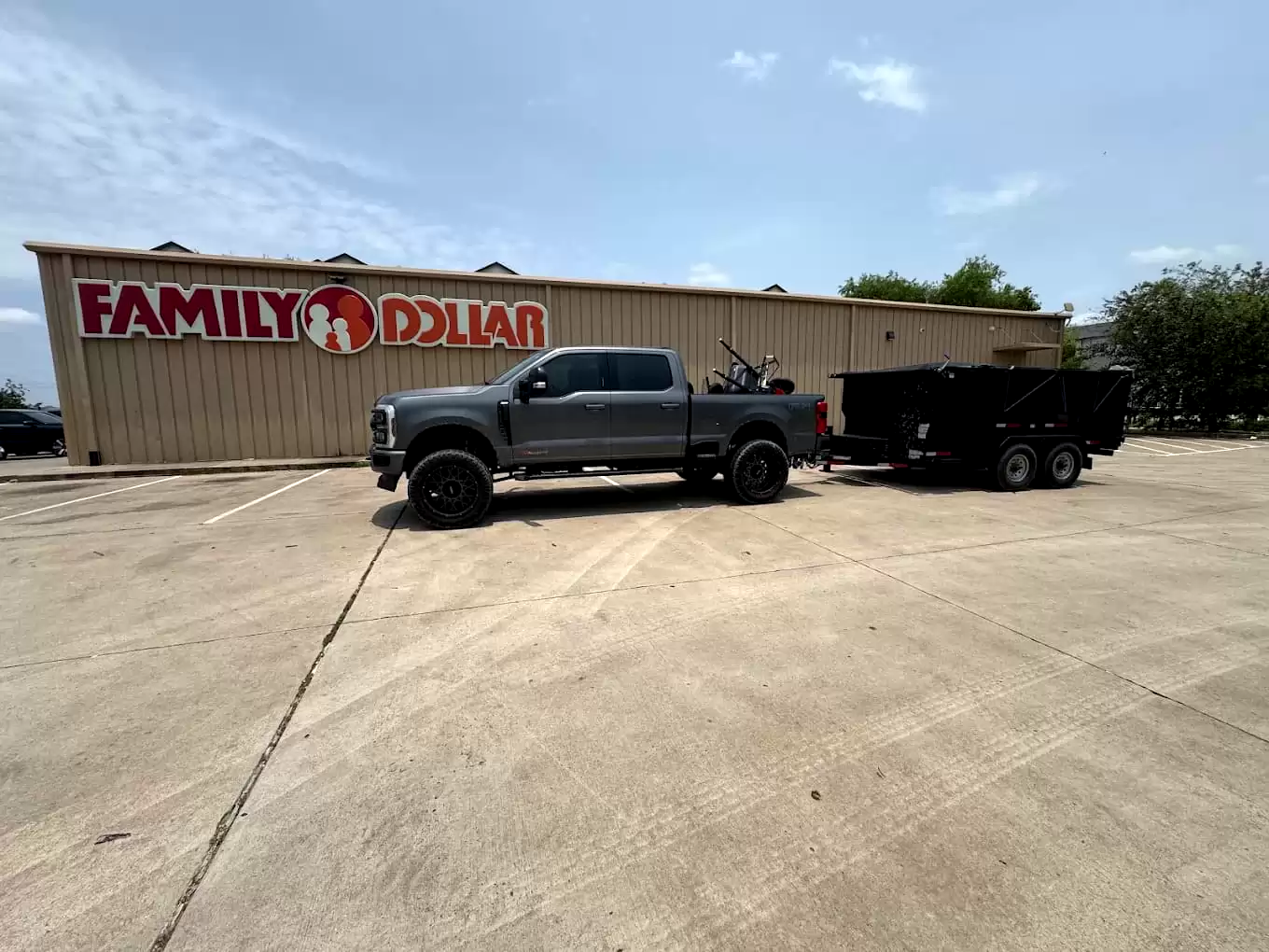 Pickup and dump trailer parked outside a store