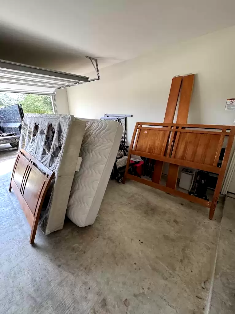 Mattresses and wooden furniture inside a garage