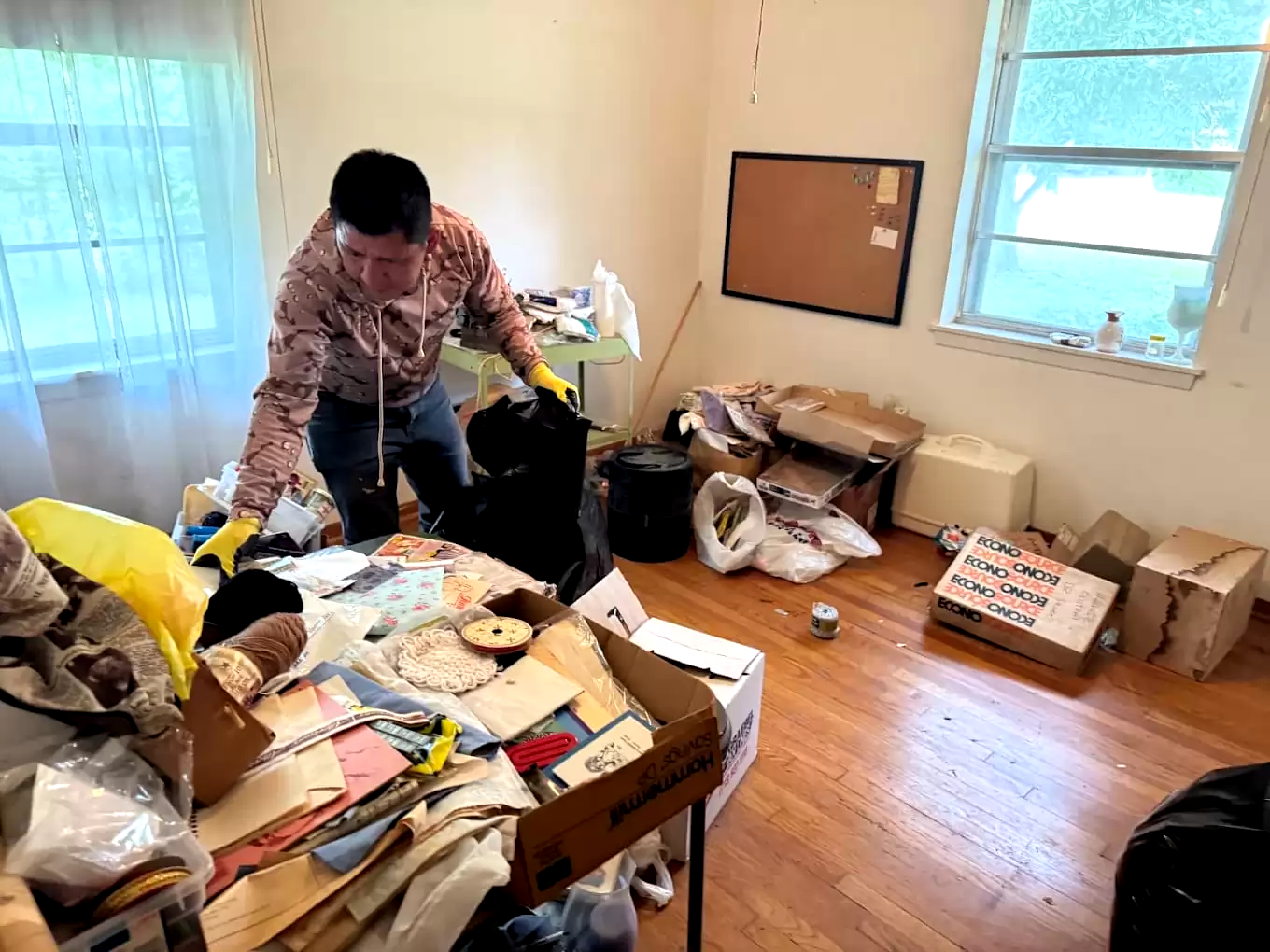 Person sorting household belongings and papers into bags