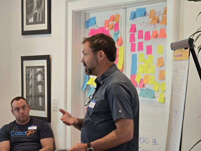 Steve Schwab leading a session in front of a sticky-note wall