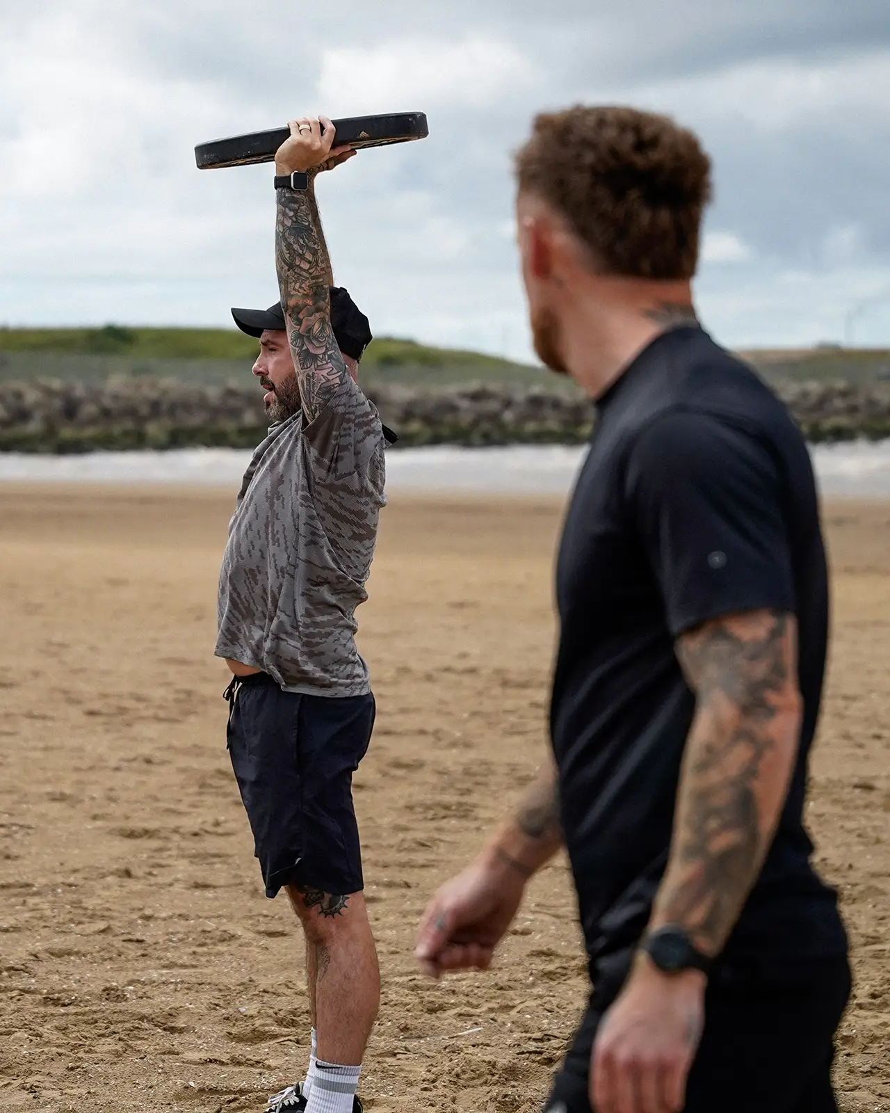 Jamie coaching a client on the beach