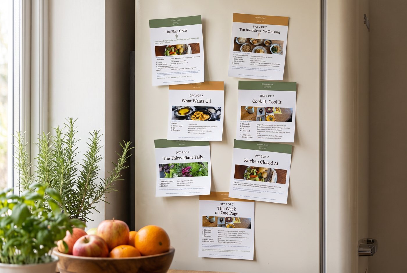 The seven printable fridge cards held to a fridge door with magnets